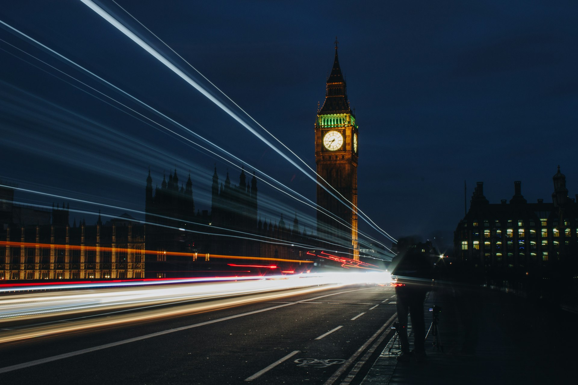 Westminster and the London skyline at night, light trails on the road