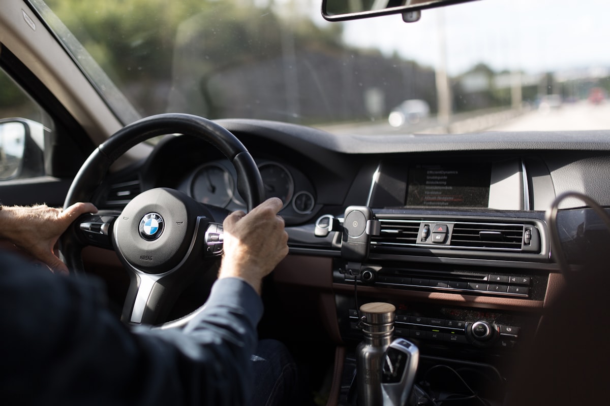 A professional chauffeur at the wheel of a Mercedes in London